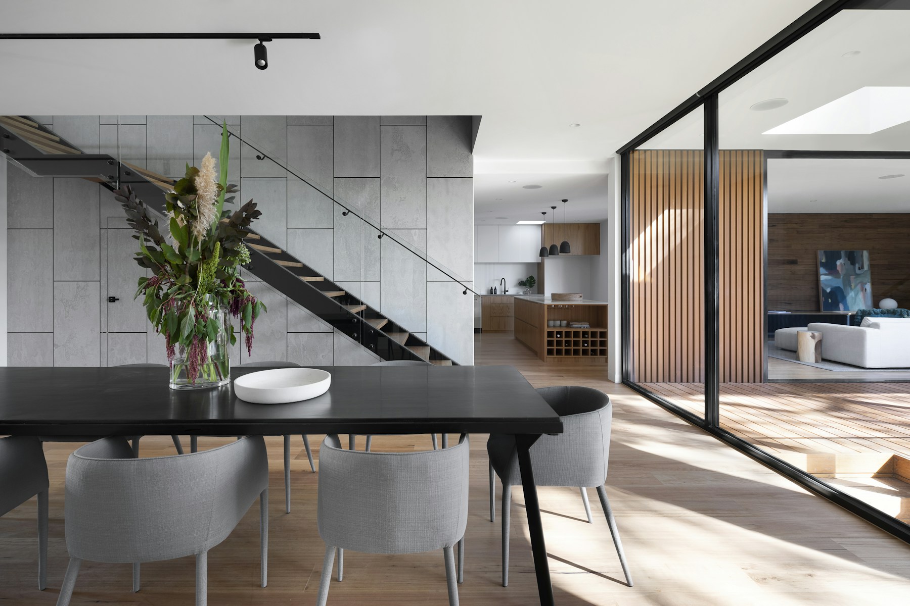 Sunlit open-plan interior with timber details and a dining area